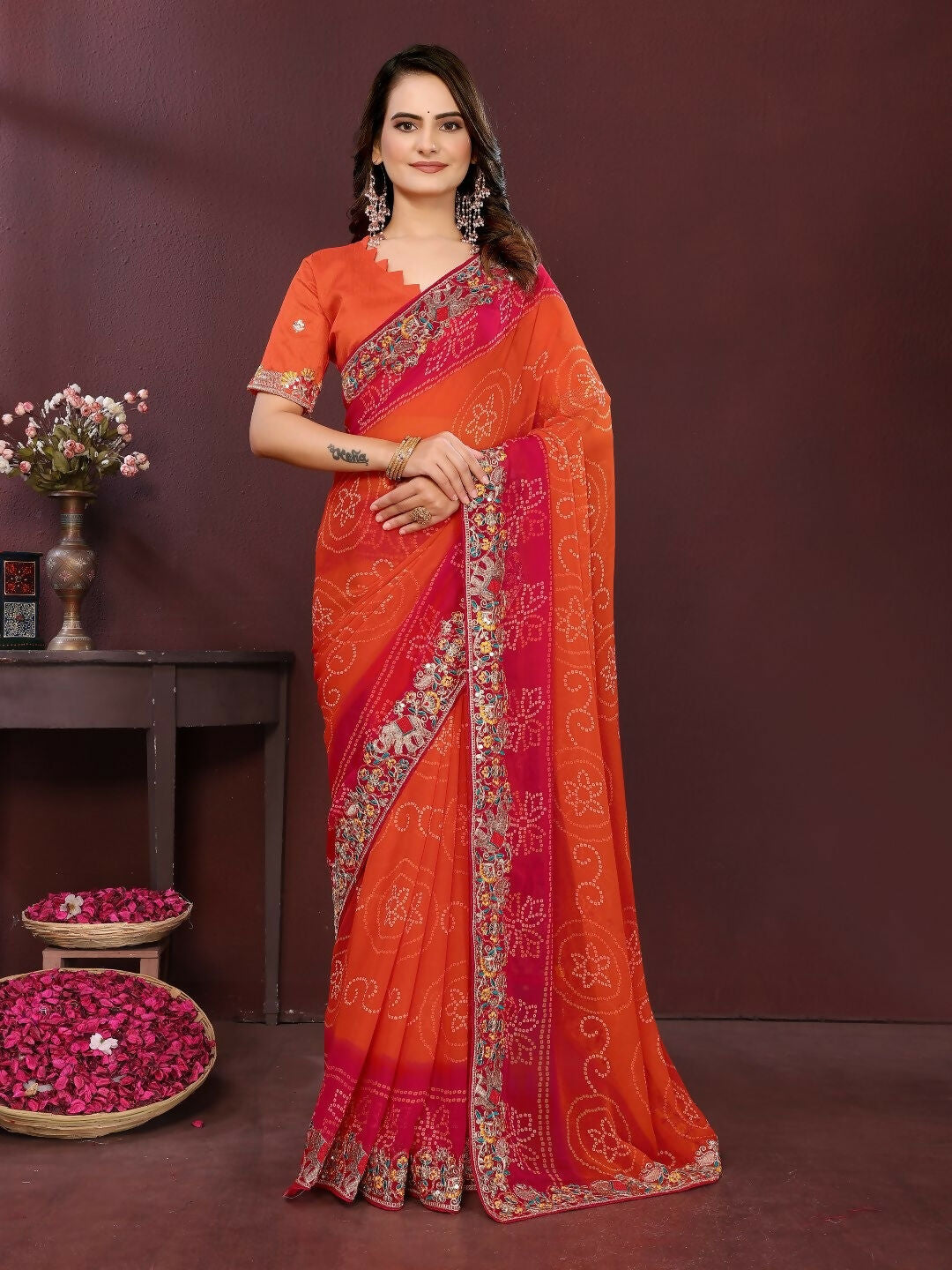 Stunning orange georgette saree adorned with a detailed digital print.