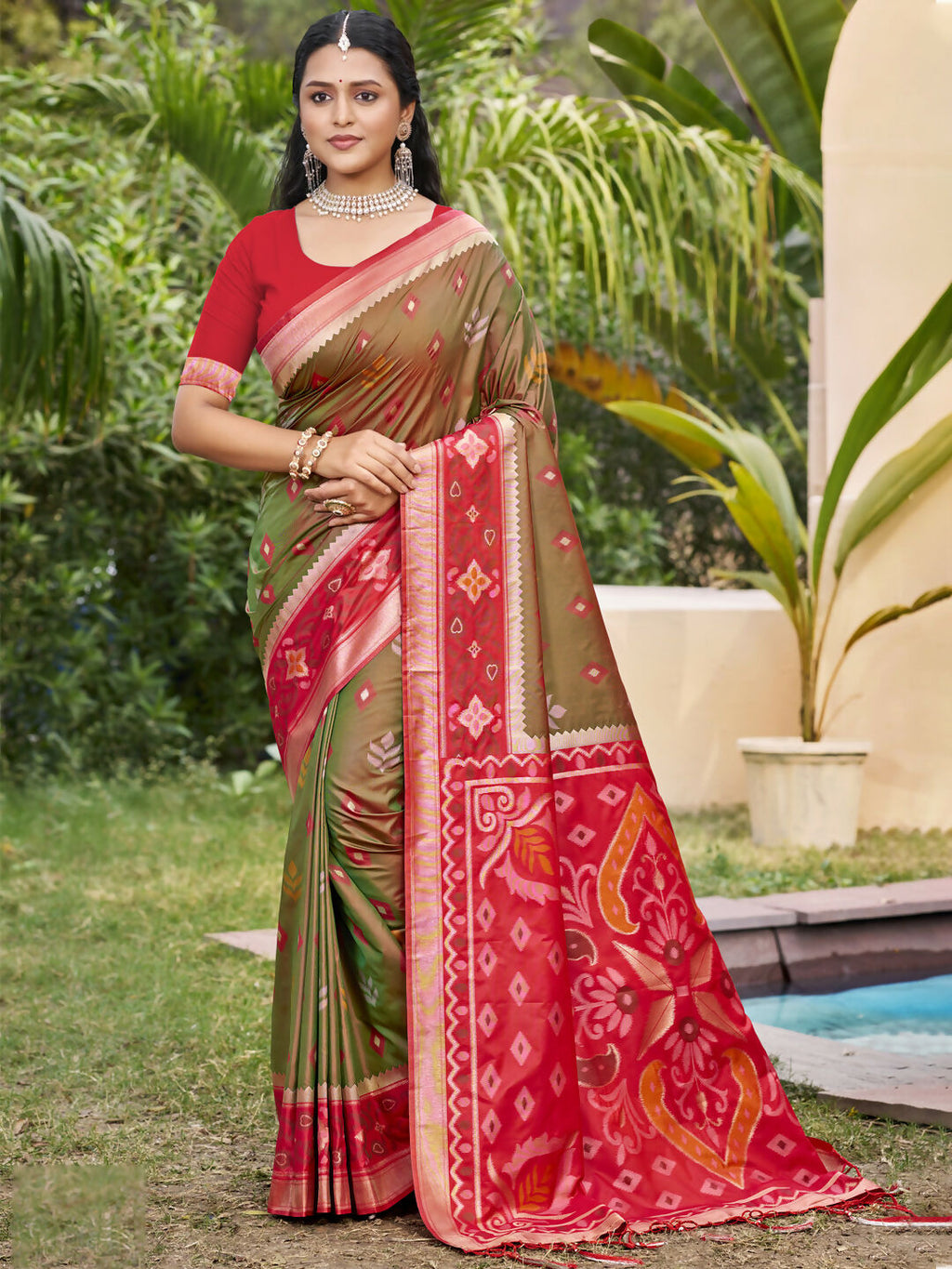 Mehndi colored Pochampally silk saree with matching blouse piece draped elegantly.