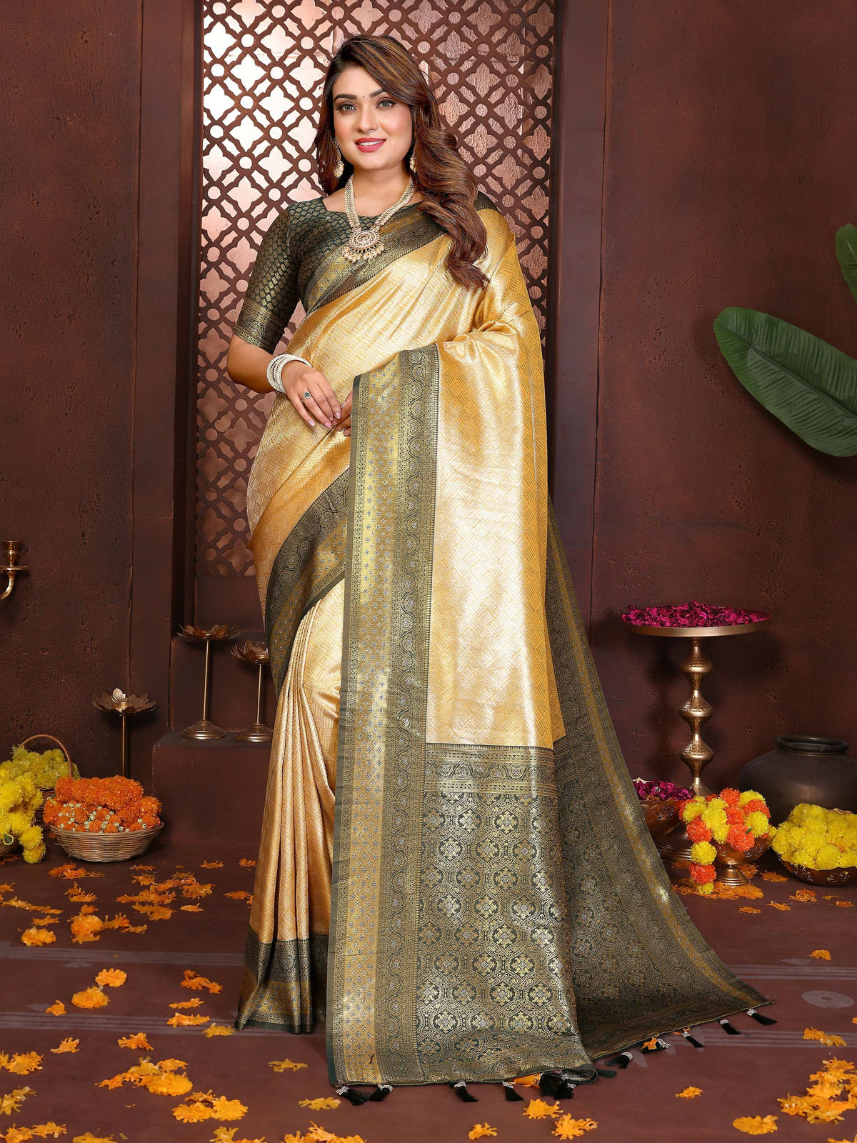 A close-up view of a cream tissue silk woven saree with delicate traditional patterns.