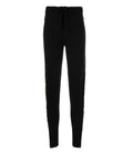 A pair of black cashmere jogger pants with a vertical metallic gold stripe down the side, shown on a model.
