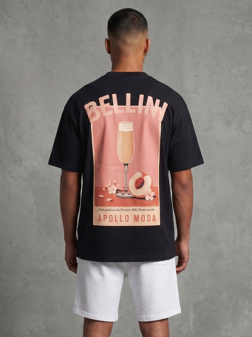 Model wearing a black Bellini oversized graphic tee with peach and pink vintage cocktail print on the back.