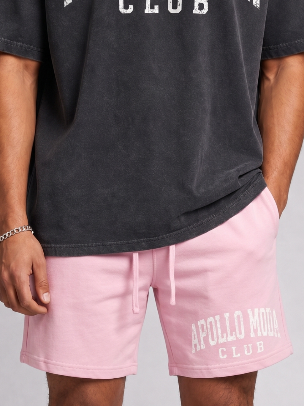 Close up of men's pastel pink heavyweight 100% cotton knit sweat shorts featuring a relaxed above-the-knee fit.