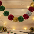 DIY no-knit pom pom garland draped elegantly on a fireplace mantel for holiday decor