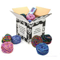 A colorful variety of reclaimed silk yarn skeins in a vibrant, bohemian, multicolored palette with metallic accents.