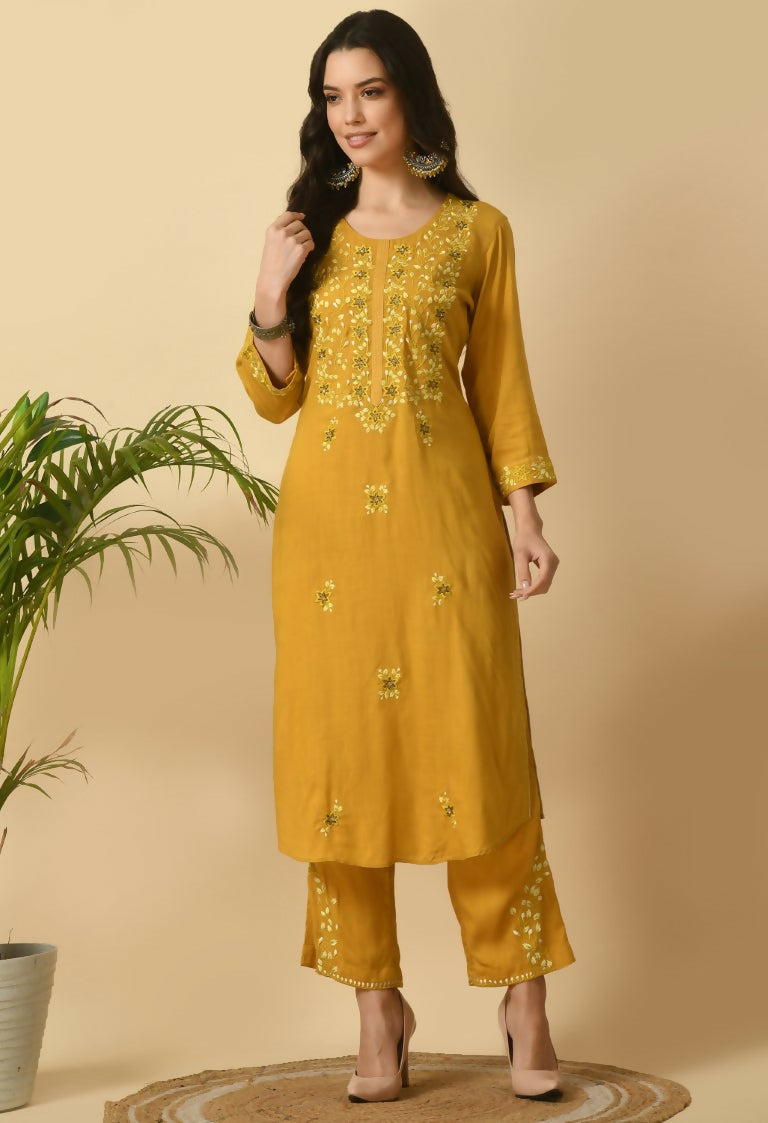 Model wearing a mustard color two-piece cotton rayon kurta set with simple ethnic styling.