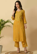 Model wearing a mustard color two-piece cotton rayon kurta set with simple ethnic styling.