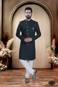 Young boy wearing a green self-design Indo-Western kurta with matching pyjama trousers