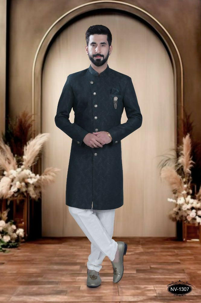 Young boy wearing a green self-design Indo-Western kurta with matching pyjama trousers