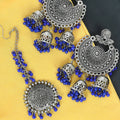 Silver tone Jhumka earrings paired with a matching traditional Maang Tikka