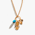 Oasis Charm Necklace featuring a gold ring pendant with four boho charms and turquoise-colored stones.