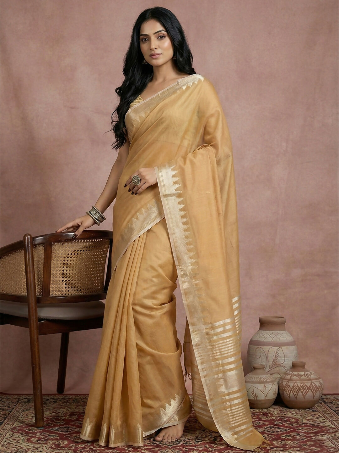 Elegant golden cotton saree with matching blouse piece draped gracefully