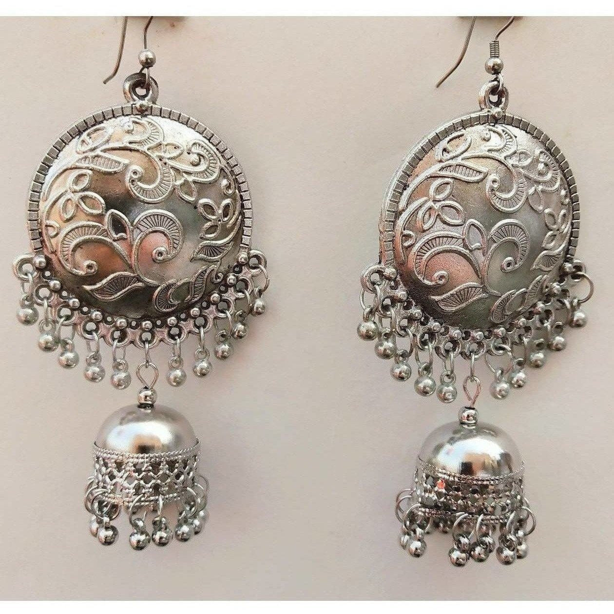 Oxidized silver chandbali jhumka earrings with tassel danglers on a clean background