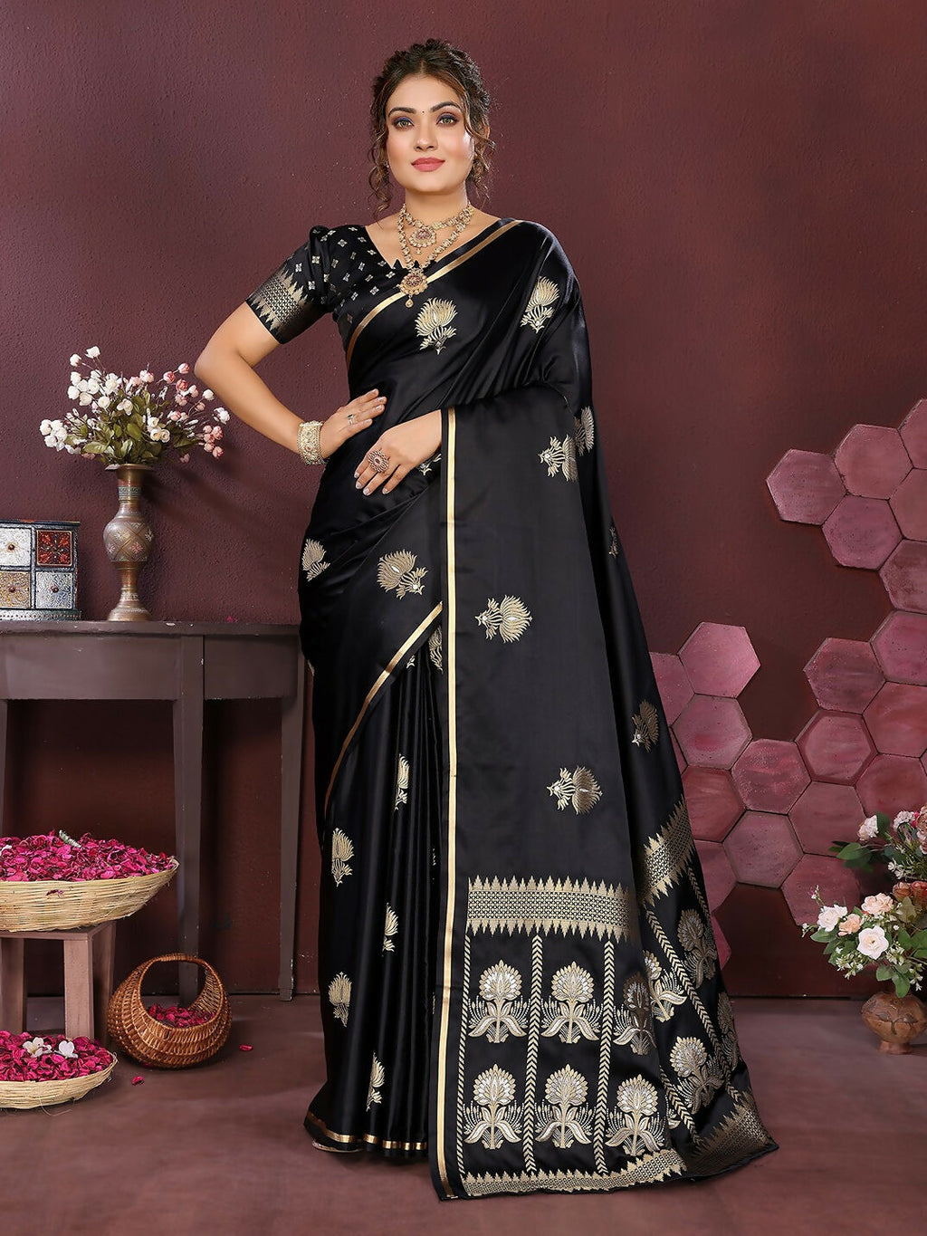 Black satin silk Banarasi saree with floral motifs and an unstitched blouse.