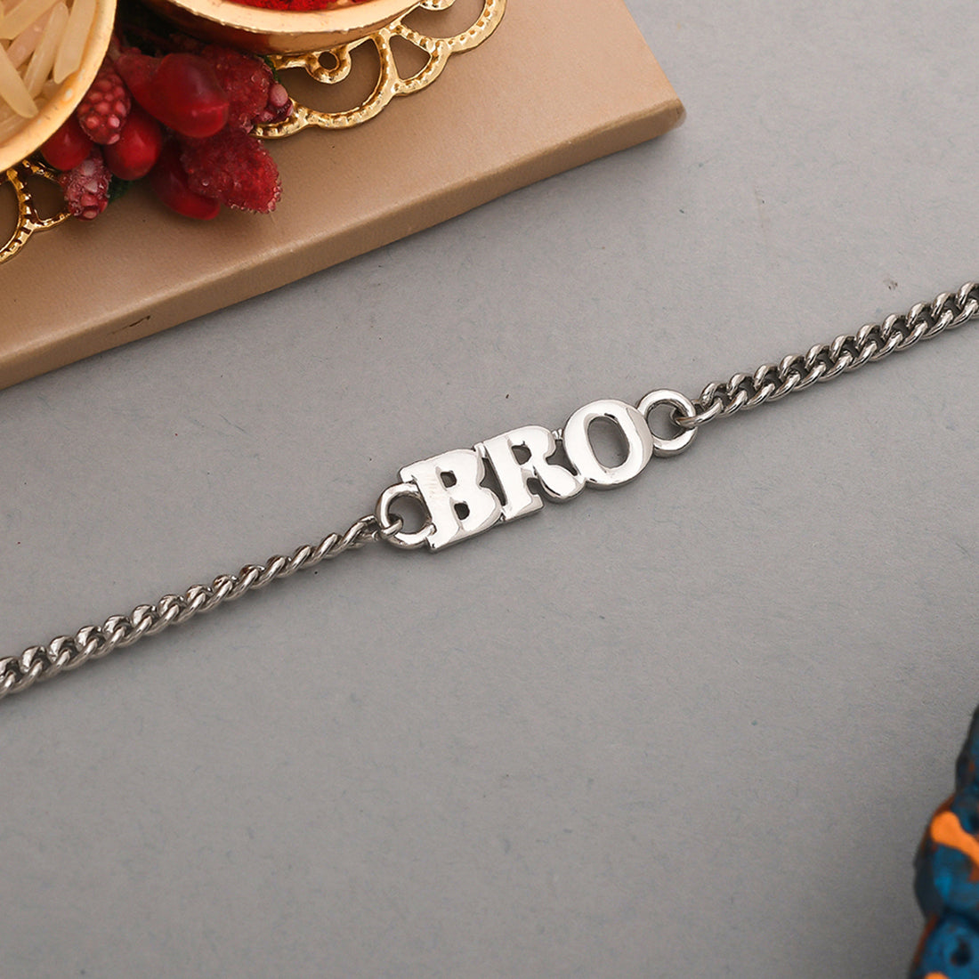 Silver tone BRO bracelet rakhi designed for men, worn as a stylish wrist accessory