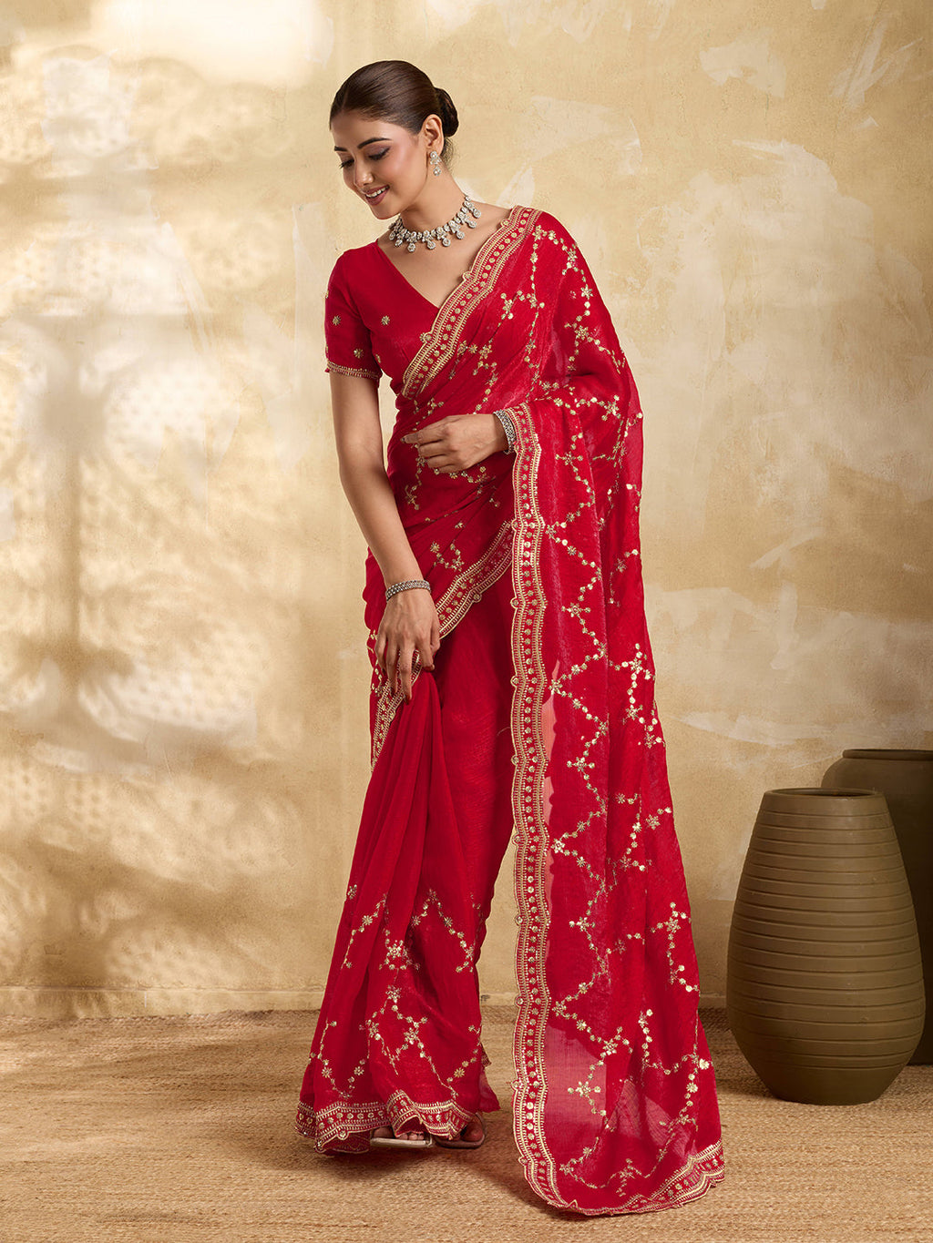 Vibrant red Jimmy Choo party wear saree with sequin embroidery and matching unstitched blouse