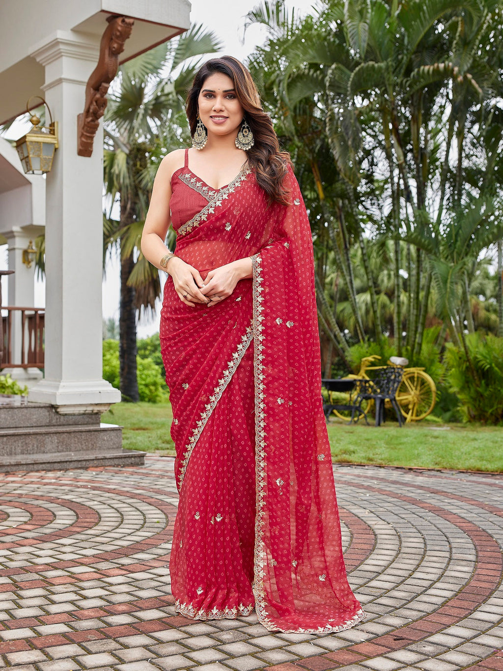 A beautiful maroon georgette party wear saree with intricate embroidery and an unstitched art silk blouse.
