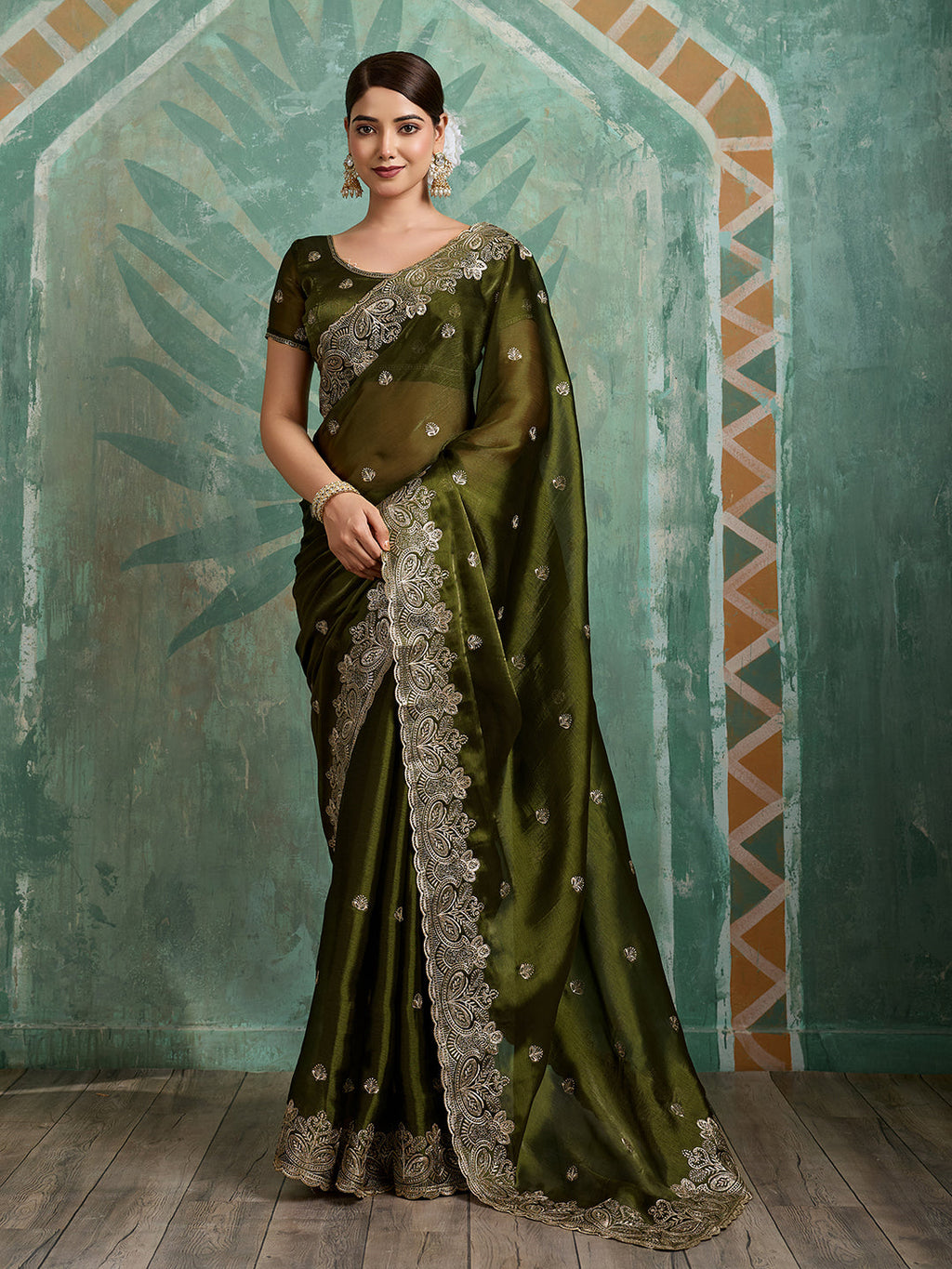 Stunning green party wear Jimmy Choo Organza saree with elaborate embroidery and unstitched blouse fabric.