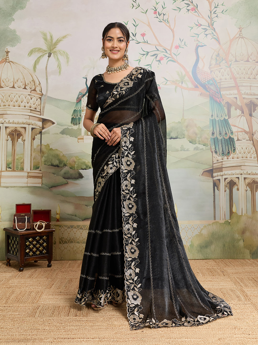 Elegant black Jimmy Choo Organza saree with detailed embroidery and unstitched blouse for party wear.