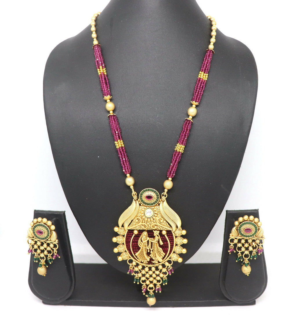 Traditional magenta necklace set with Rajwadi gold polish and stone embellishments