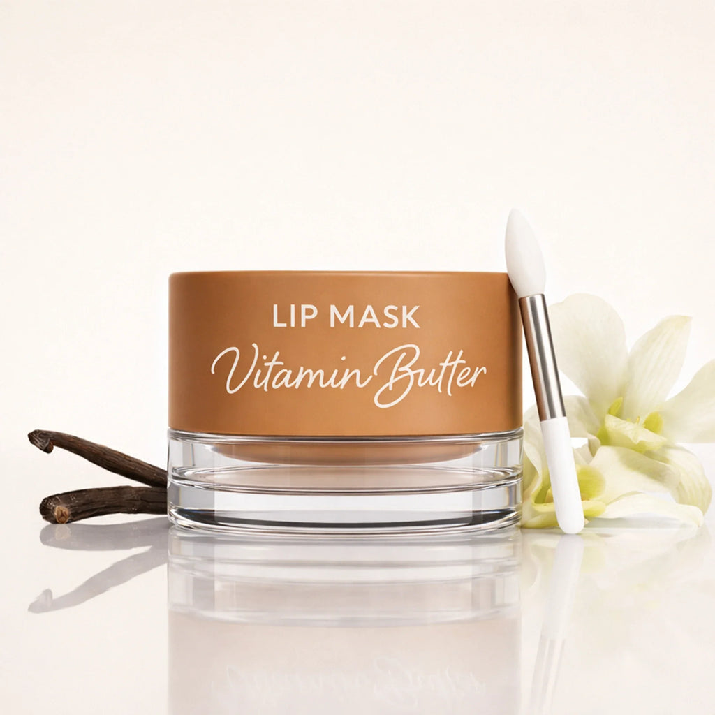Jar of Vanilla Vitamin Butter lip mask with an applicator brush next to vanilla beans