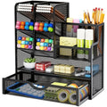 A black multi-layer iron mesh desk organizer holding various pens, markers, and office supplies on a clean desktop.