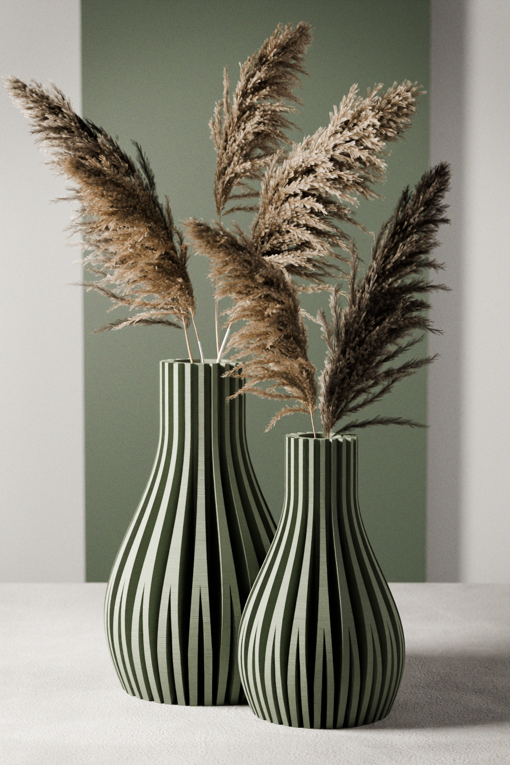Set of two ribbed modern Willow vases in green and neutral tones displayed on a table