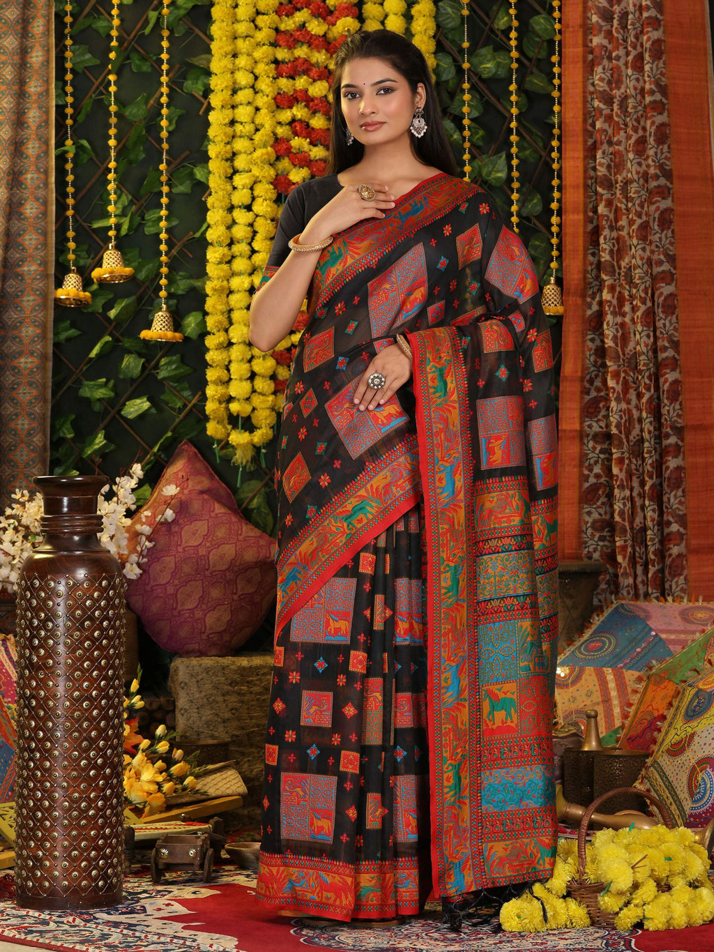 A woman wearing a classic black linen cotton saree with matching black blouse.