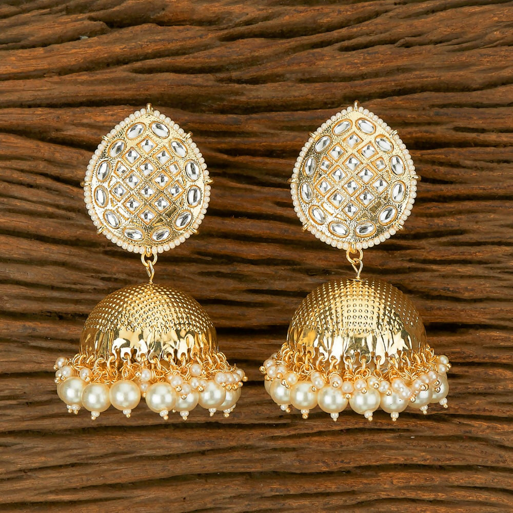 A pair of traditional golden white Kundan and Pearl drop earrings for women