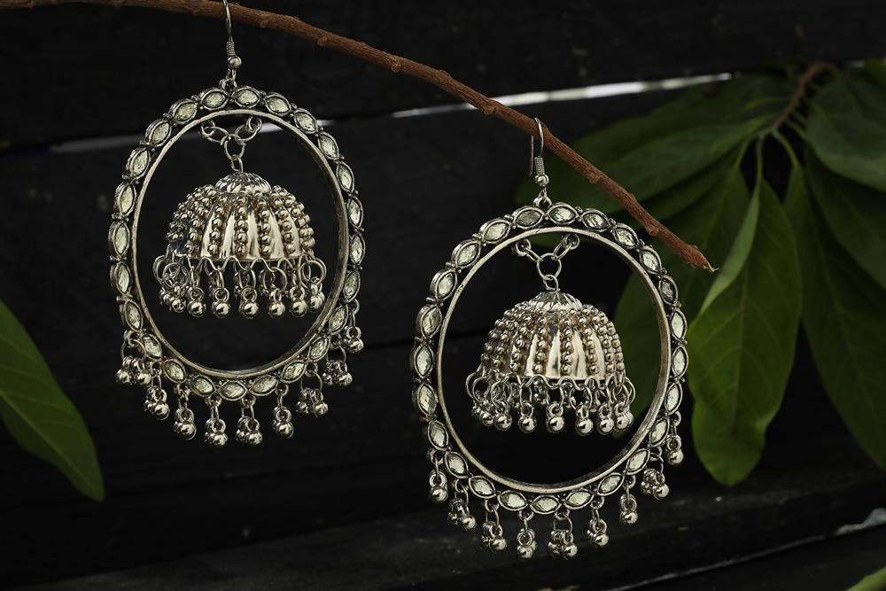 Traditional silver-plated Jhumka earrings featuring intricate Kundan detailing for ethnic wear.