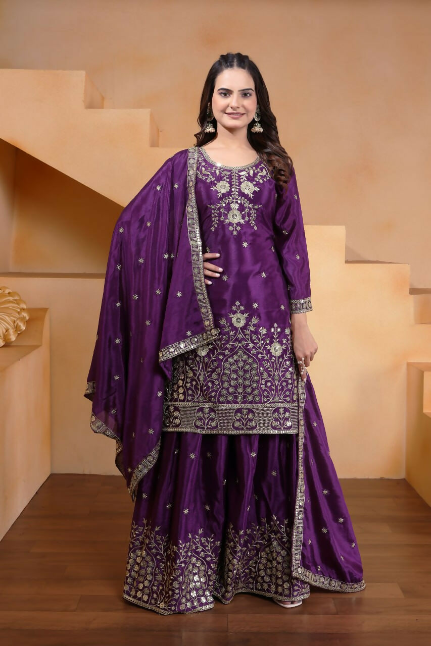 Model wearing a premium purple silk sharara set with intricate embroidery and wide-leg trousers.