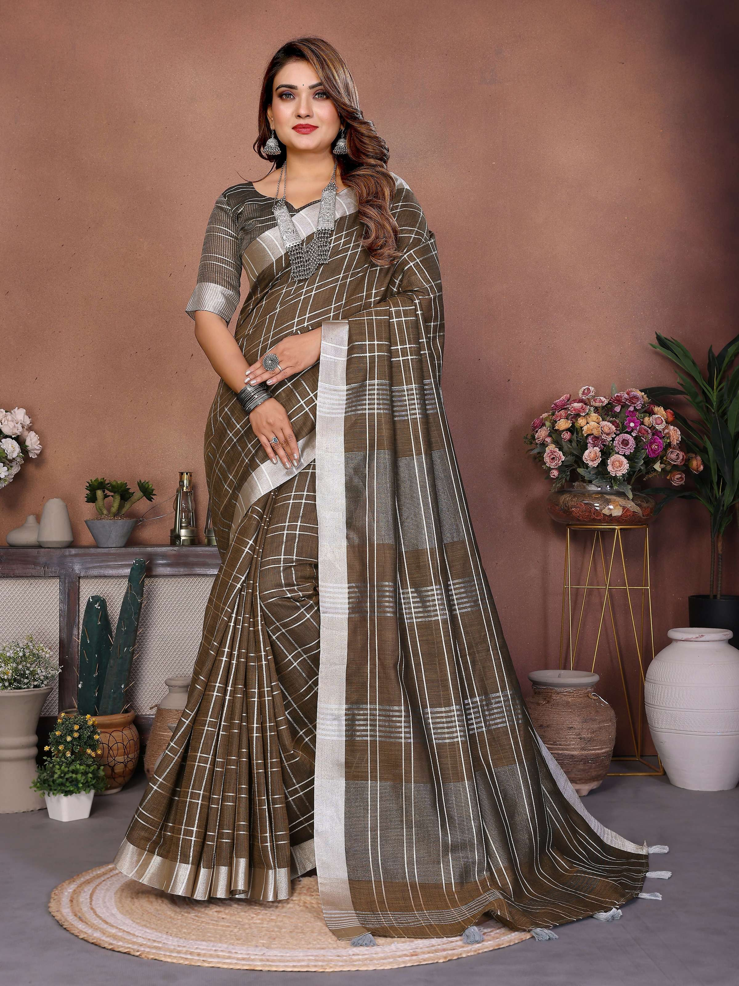 A close-up view of a light brown linen weaving saree showcasing the texture and woven patterns.