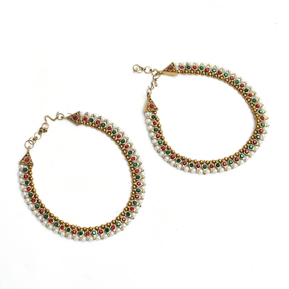 Close-up of gold-plated multi-color Kundan and pearl anklets for women, ethnic design