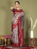 Teal Lichi Silk saree paired with a purple blouse.