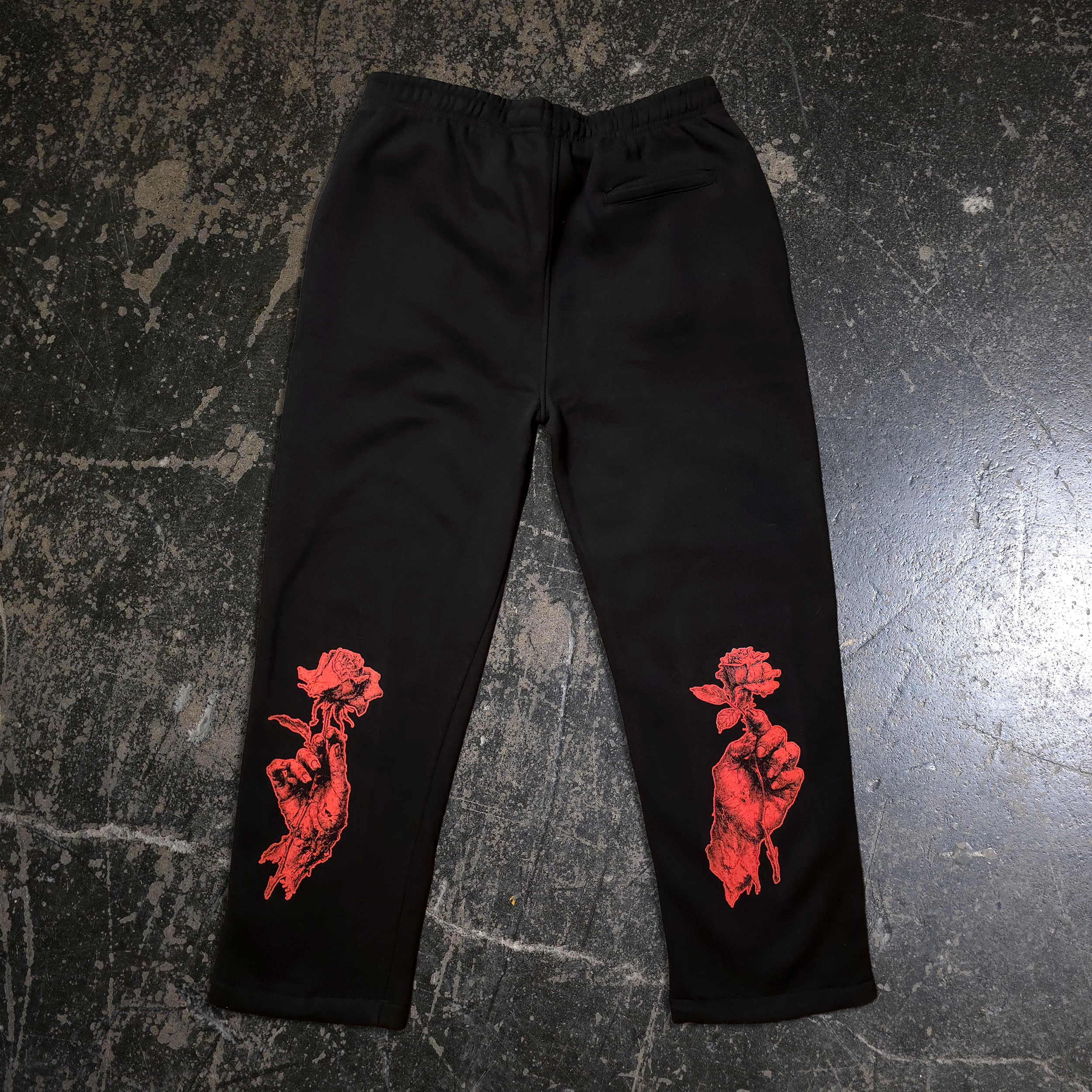 Black heavyweight fleece sweatpants with When Death Comes red graphic art on the knees and back pocket.