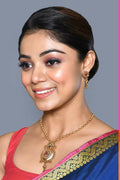 Golden Ruby Green Jadau Kundan pendant set with matching earrings.