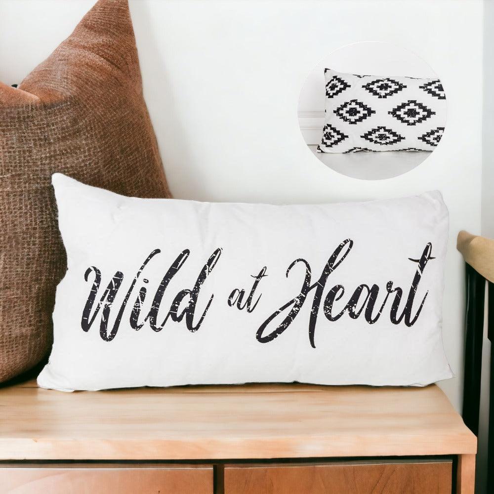 Decorative canvas throw pillow with Wild at Heart text on the front and a black and white geometric pattern on the reverse side.