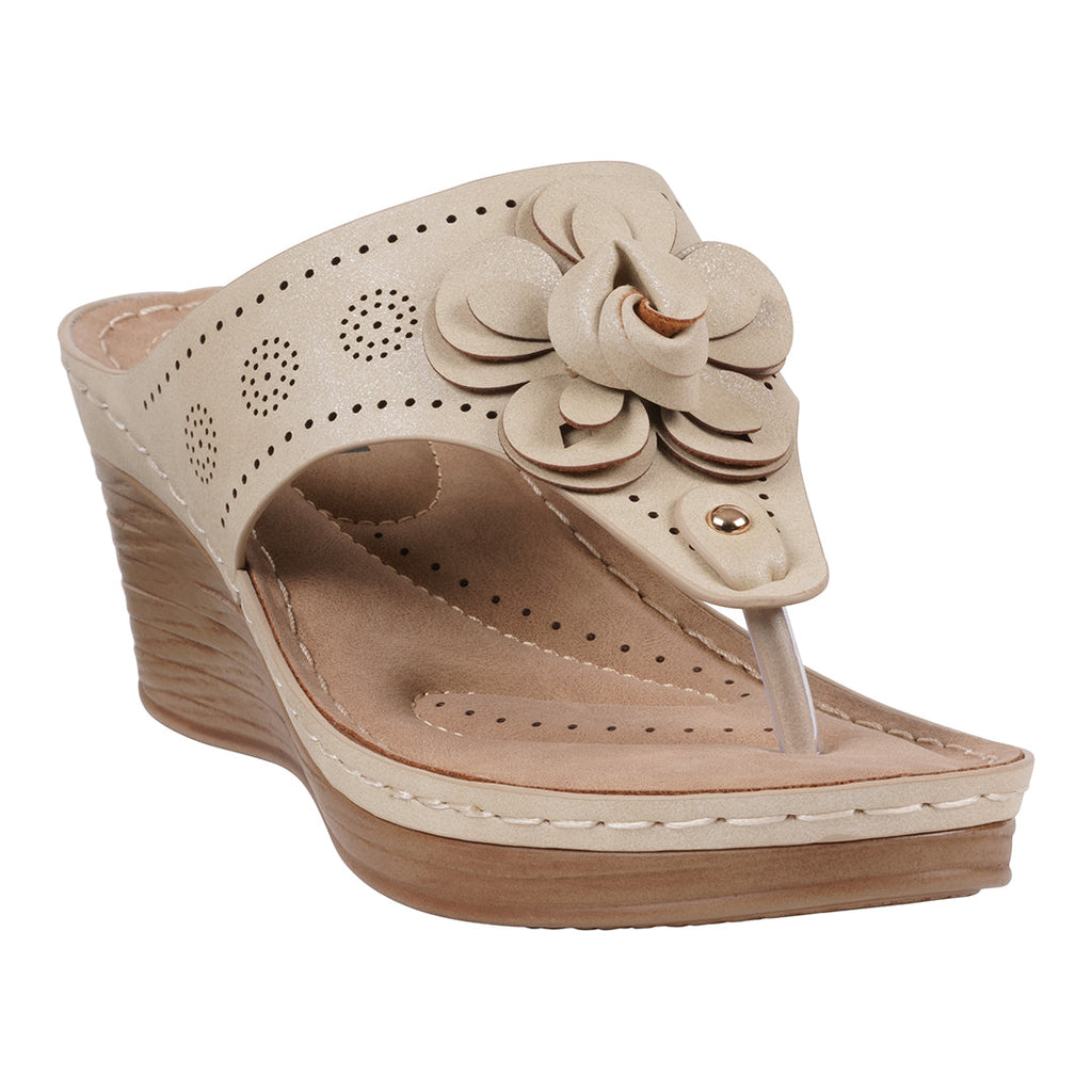 A pair of gold floral wedge sandals with perforated details and a cushioned footbed, shown from a side and top angle.