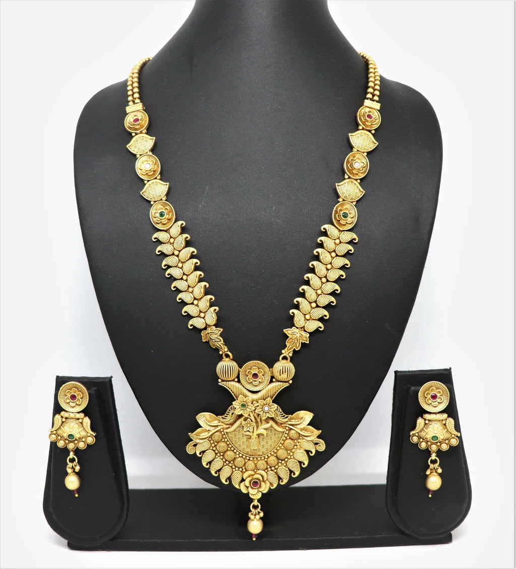 Close up of a traditional gold mango design brass necklace set with Rajwadi polish and stone embellishments.