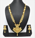 Close up of a traditional gold mango design brass necklace set with Rajwadi polish and stone embellishments.