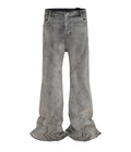 Front view of grey wash wide leg flared denim jeans with structural seam detailing on the thighs.