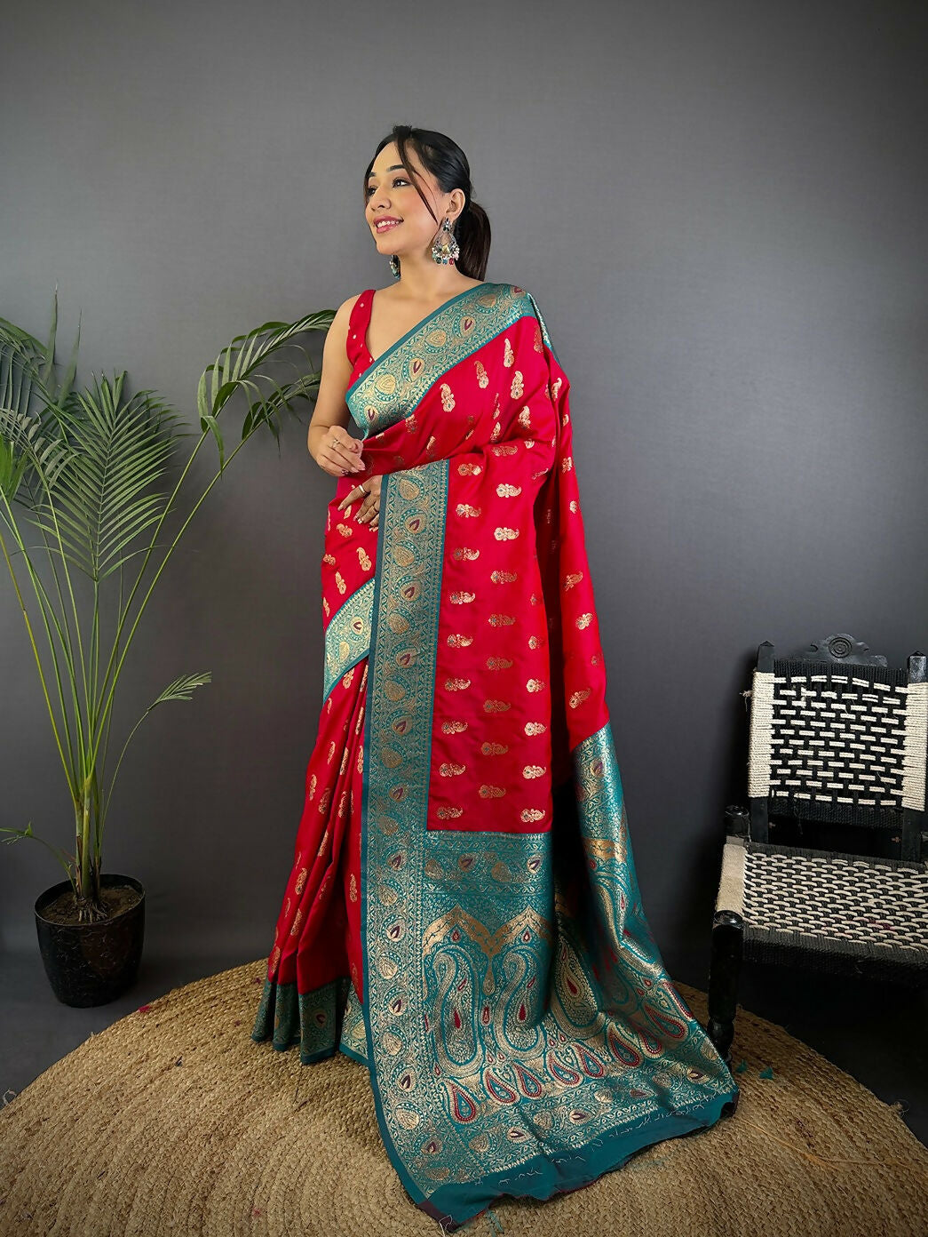 Red Banarasi soft silk saree with traditional woven butti patterns and matching blouse fabric.