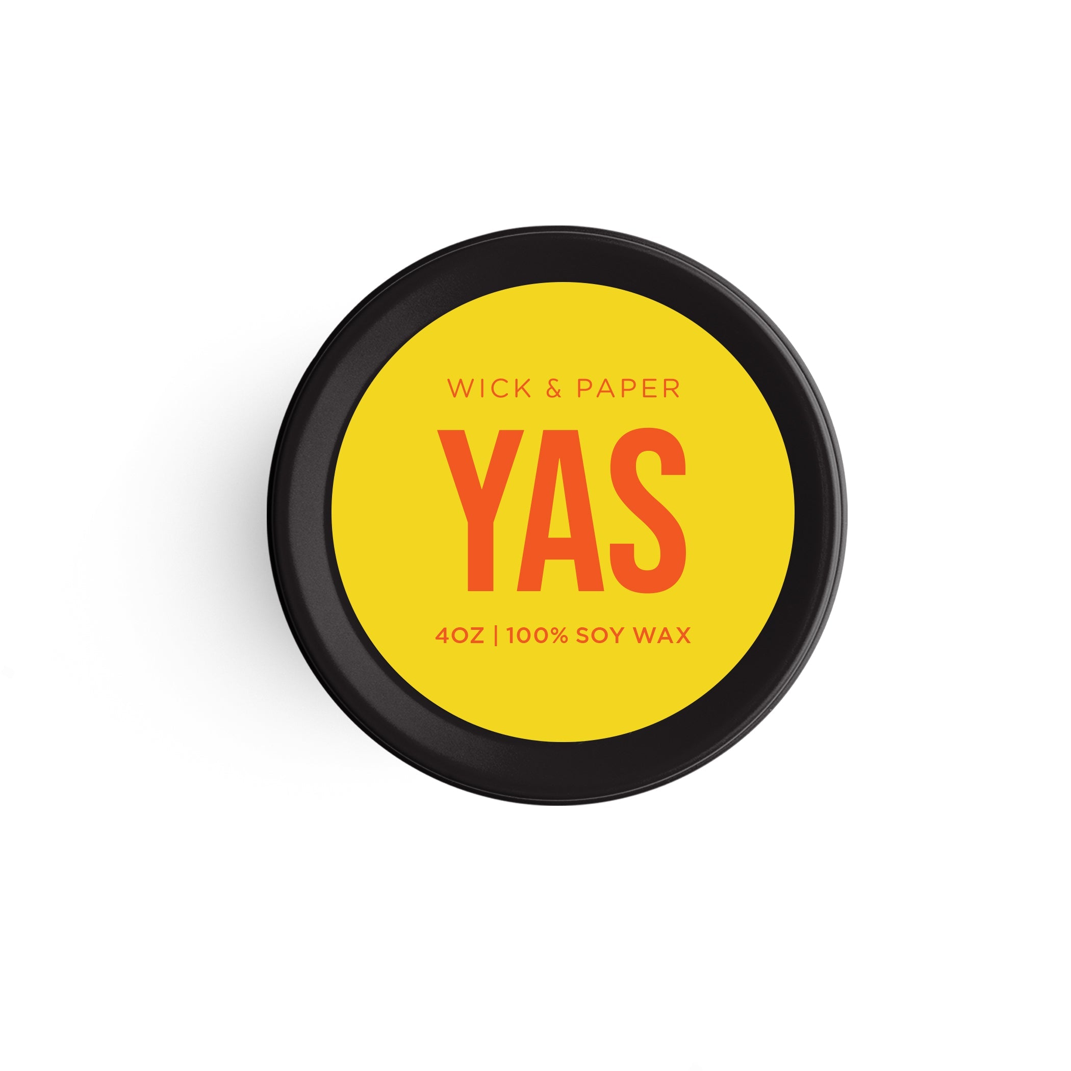 YAS soy wax candle in a black tin container with a bright yellow label.