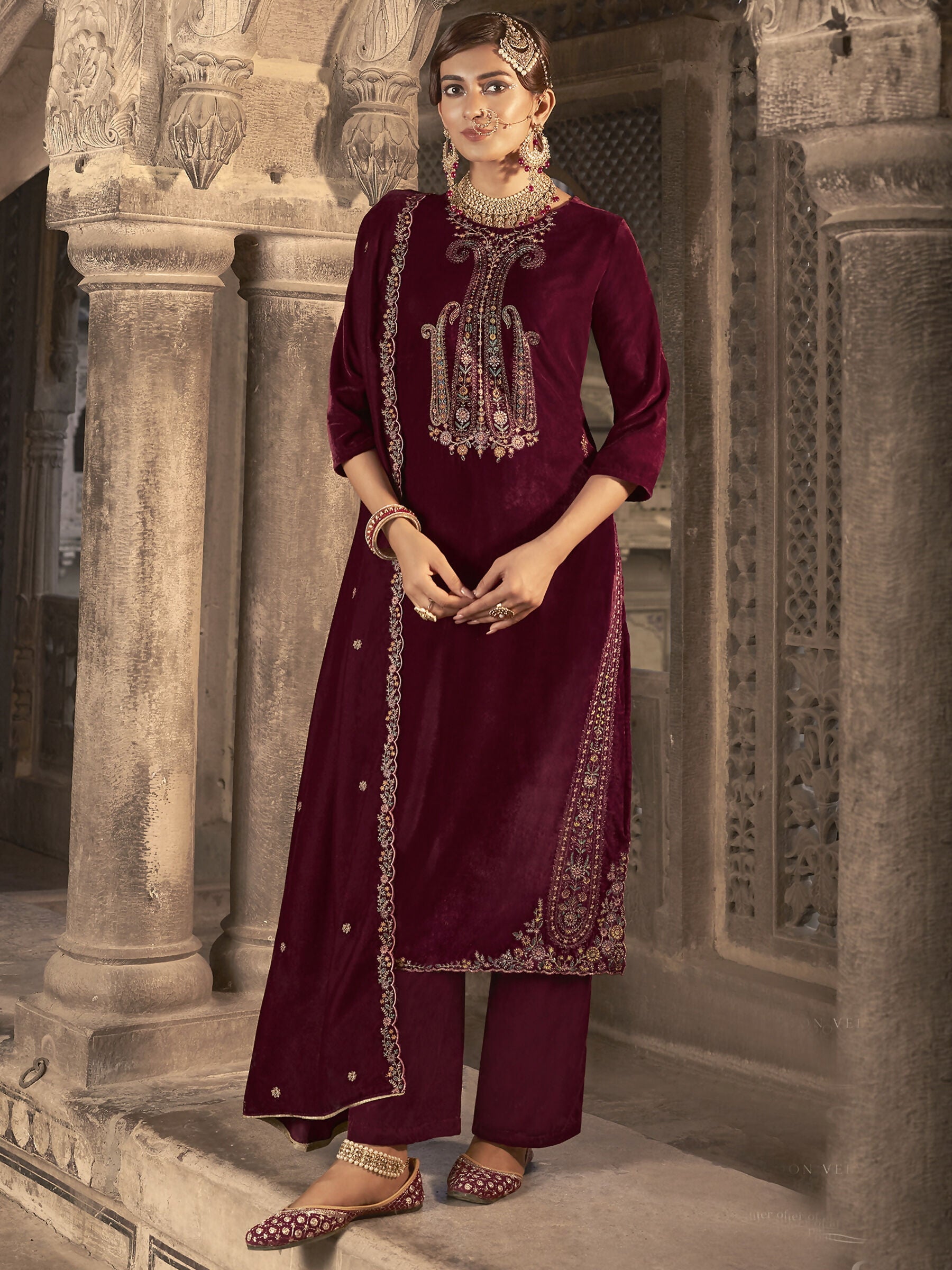 Maroon velvet straight kurta featuring floral Resham thread and Jari embroidery with matching trousers.