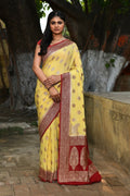Light and airy pale yellow crepe chiffon Banarasi handloom saree.
