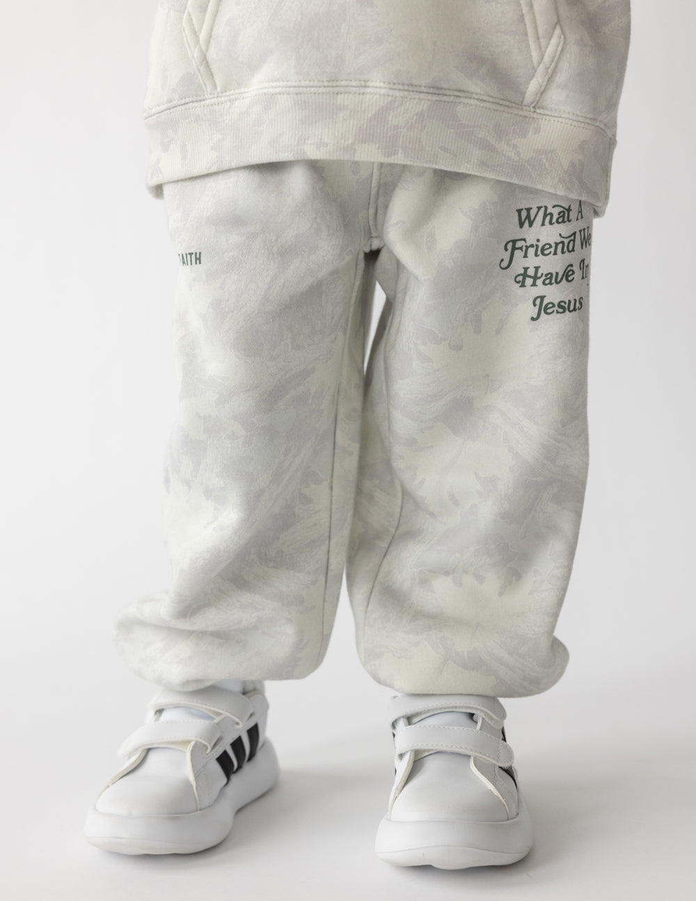 Kids wearing grey and white tonal camo print knit sweatpants with a relaxed, tapered fit.