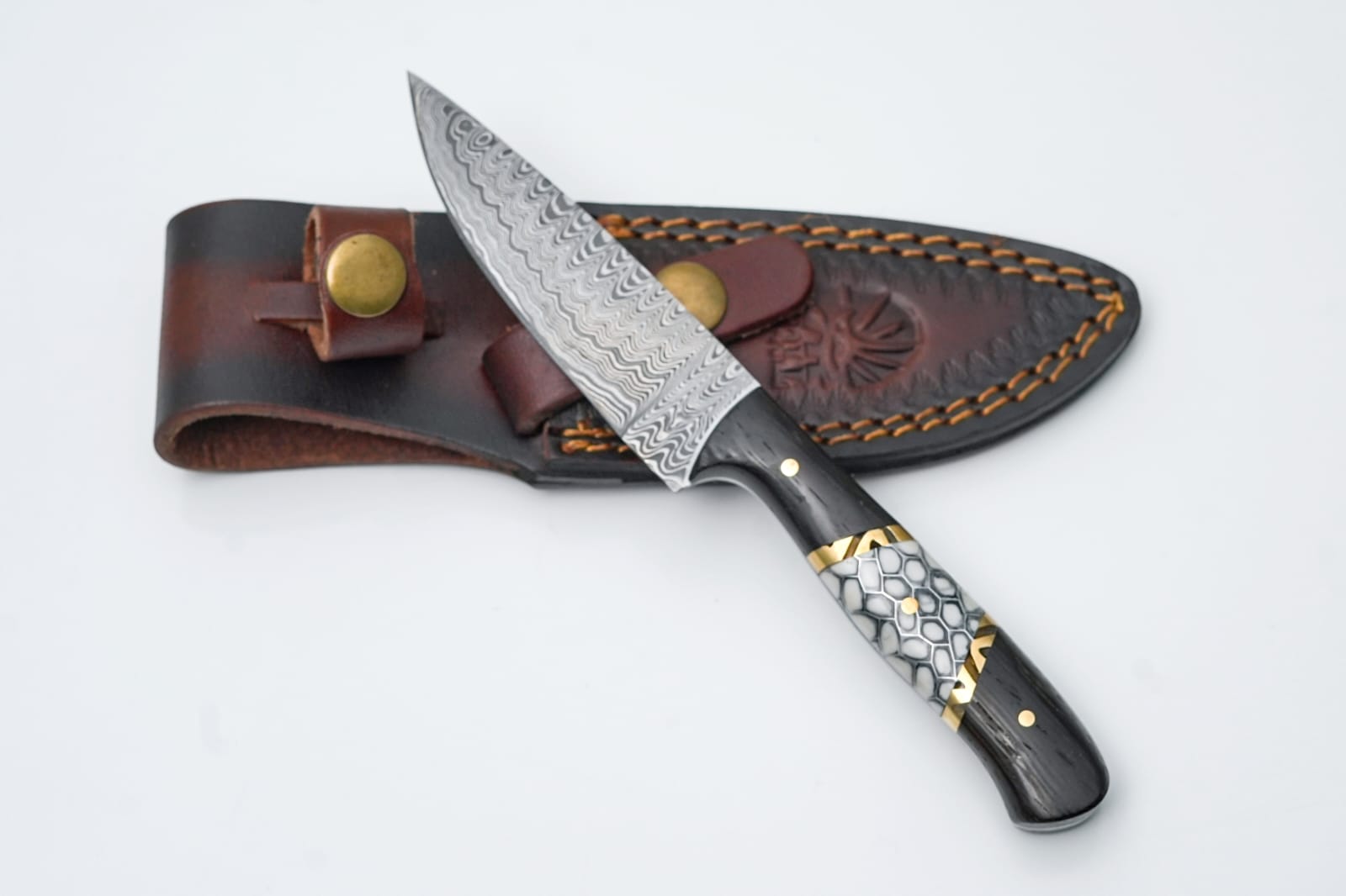 HexForge Damascus steel utility knife with geometric blade pattern and multi-tone handle