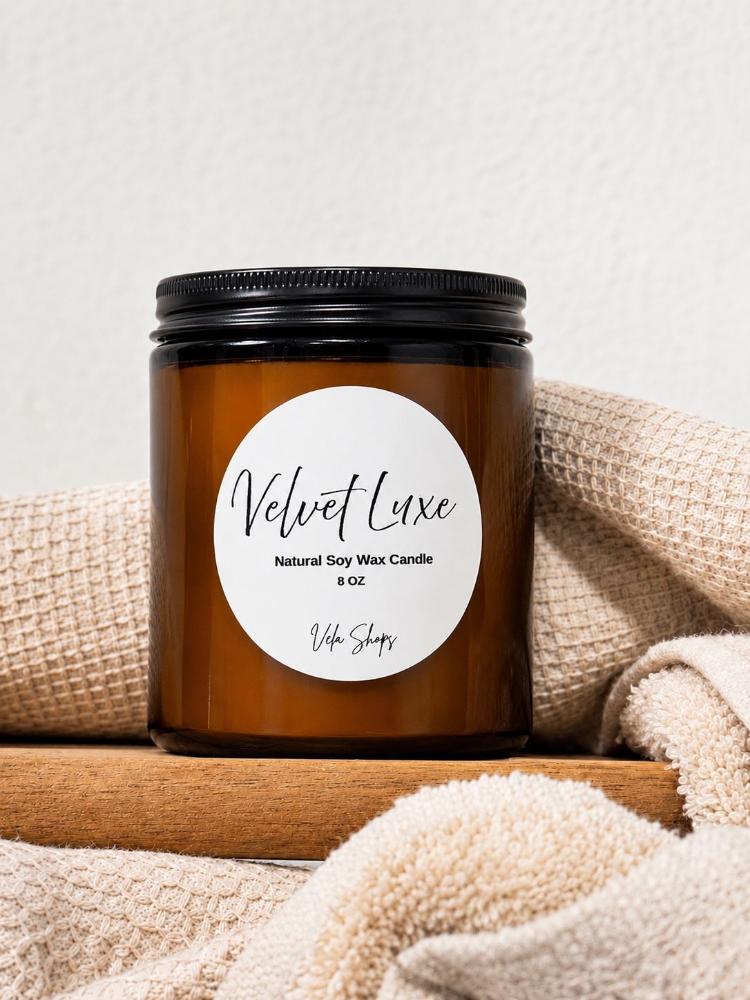 Velvet Luxe soy wax candle in an amber glass jar with minimalist black labeling.