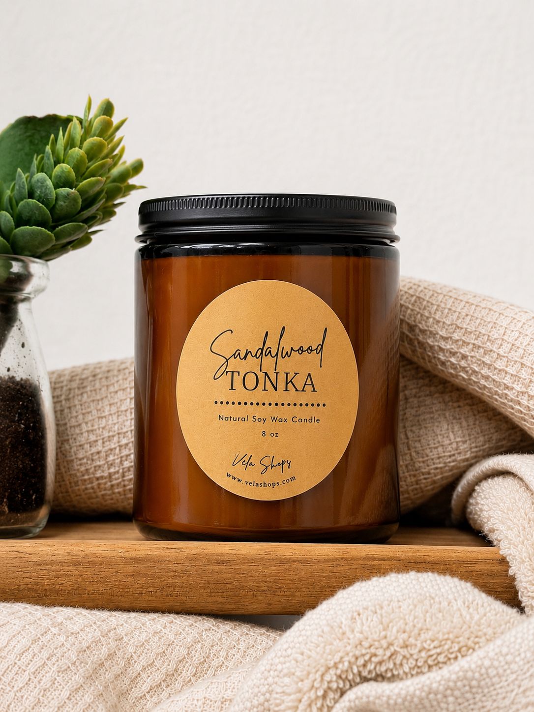 Amber glass jar containing an 8oz Sandalwood and Tonka soy wax candle.