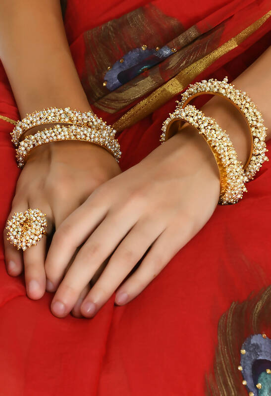 Gold-polished brass bangles and matching rings with off-white bead detailing