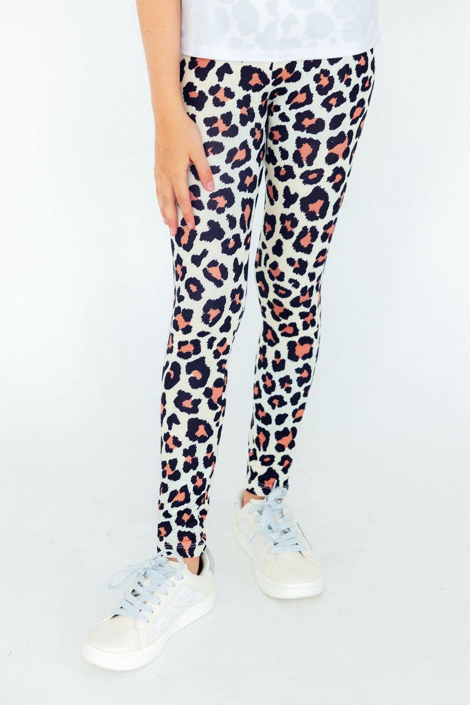Young girl wearing high-waisted leopard print leggings with a slim fit